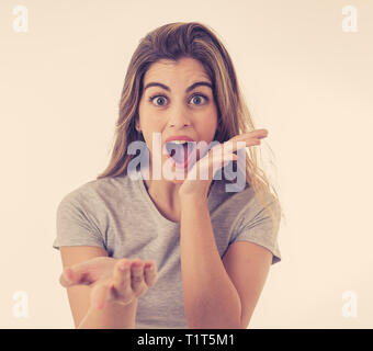 Très belle jeune femme blonde avec un visage heureux en soulignant et en faisant des gestes et surpris quelque chose de choquant et bon. Les droits de l'expression du visage Banque D'Images