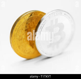 Version physique d'argent et d'or des bitcoins sur fond blanc. Banque D'Images