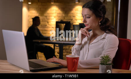 De jeunes pousses libre occupé caucasian businesswoman typing sur l'ordinateur portable d'être concentré un concentré à l'intérieur sur le lieu de travail Banque D'Images