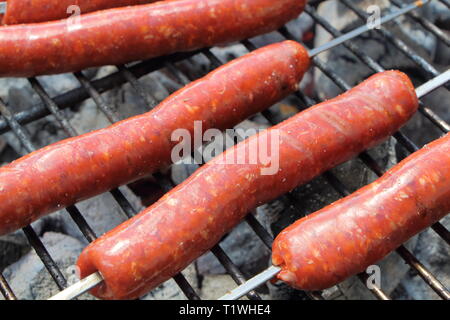 Merguez sur le rack d'un barbecue Banque D'Images