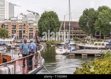 Deux hommes étaient debout à parler sur un bateau à Saint Katherine's marina à Londres Banque D'Images