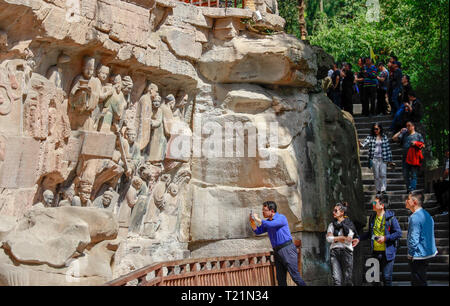 Chongqing, Chine. Mar 29, 2019. Les touristes voir sculptures sur roc à la zone panoramique de Sculptures rupestres de Dazu Dazu dans district de Chongqing, au sud-ouest de la Chine, le 29 mars 2019. Les sculptures datant du 9ème au 13ème siècles ont été inscrits sur la liste du patrimoine mondial par l'UNESCO en 1999. Credit : Liu Chan/Xinhua/Alamy Live News Banque D'Images