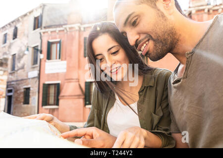 L'Italie, Venise, young couple looking at map dans la ville Banque D'Images