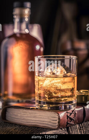 Verre de whisky avec de la glace sur l'ancien journal Banque D'Images