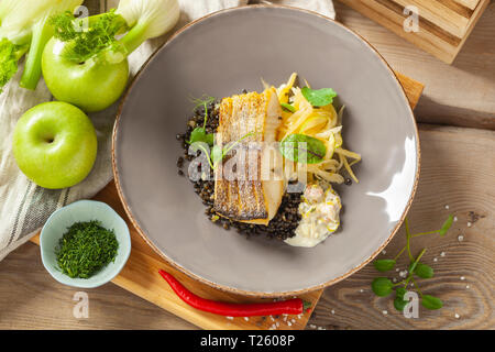 Le merlu marinés dans l'huile de citron avec lentilles noir avec du chili et le céleri, sauce écrevisses Banque D'Images