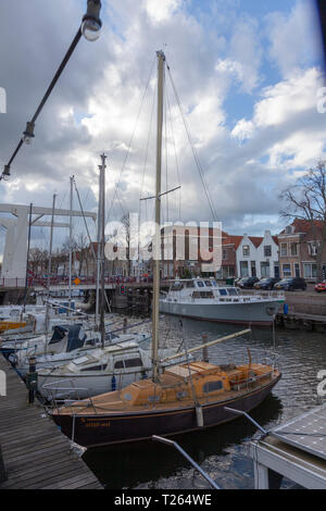 Bateaux dans la plate-forme de l'autre côté du canal sous ciel nuageux, brille, Pays-Bas Banque D'Images