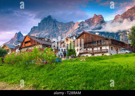 Célèbre village alpin au coucher du soleil. Alpin merveilleux maisons et jardins étonnants. De hautes montagnes au coucher du soleil à San Vito di Cadore, Dolomites, Banque D'Images