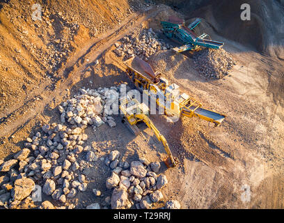 Vue panoramique au coucher du soleil de carrière de gravier,extraction de gravier de construction jaune, pompage de gravier avec de l'aide de puissantes pompes, post-apocalyptique landscapе Banque D'Images