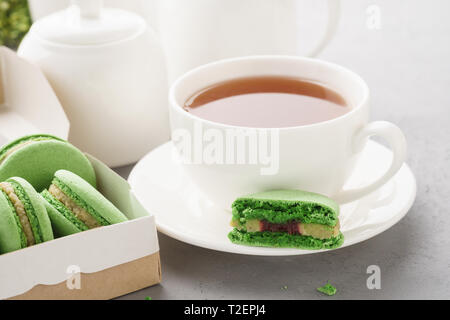 Macarons pistache avec berry le remplissage et un plateau pour le dessert. Concept traite française. Banque D'Images
