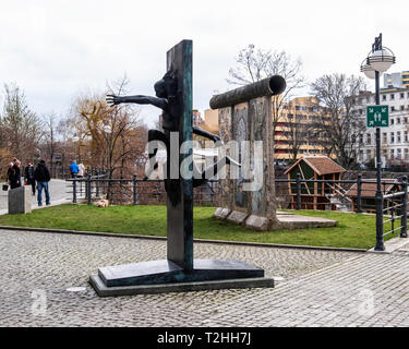 Berlin, Mitte,Moabit. Sculpture en bronze de l'homme mur briser par Rolf Bibi - symbole de la chute du Mur de Berlin sur la rue du Souvenir. Banque D'Images