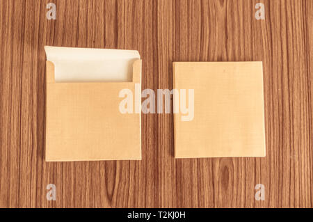 Ensemble de deux enveloppe brune avant et à l'arrière isolé sur fond de plancher de table en bois. Des cartes vierges. Immersive. Haut Haut angel afficher un objet Banque D'Images