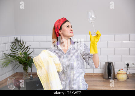 De nettoyage ou de femme verre ruges dans la cuisine. de ménage faire le nettoyage de printemps