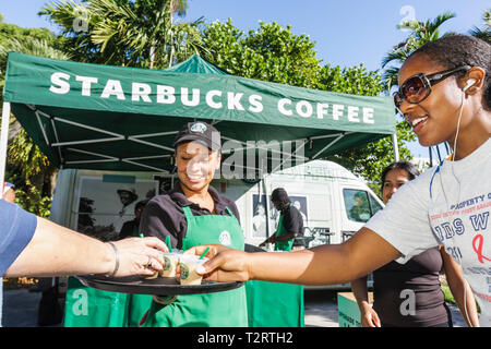 Miami Beach Florida,AIDS Walk Miami,échantillons gratuits,produit,café,Starbucks,café,barista,entreprise internationale,tente,marquage,sponsor d'entreprise,Black Wom Banque D'Images