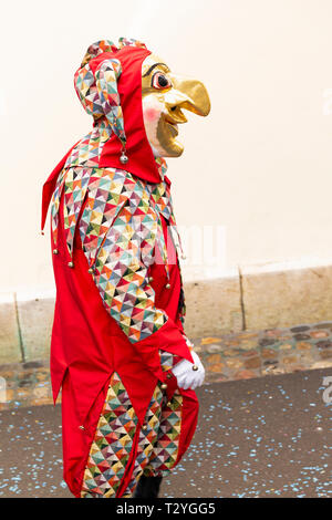 Rheinsprung, Bâle, Suisse - Mars 13th, 2019. Portrait d'un carnaval en participant avec costume rouge masque de couleur or Banque D'Images