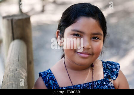 Portrait d'une jolie jeune fille portant une chemise bleu style country western dans un ranch en plein air. Banque D'Images