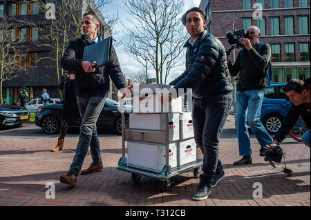 La Haye, Pays-Bas. 5ème apr 2019. Deux hommes se sont vu offrir de boîtes remplies avec les signatures contre Shell, à l'intérieur de l'immeuble de la Shell pendant la manifestation.Des centaines de personnes rassemblées au Malieveld. De là, ils marchèrent jusqu'au siège de l'industrie du pétrole et du gaz société Shell pour effectuer une livraison de plus de 13 000 signatures à l'appui de citoyens néerlandais la poursuite. Ce serait une nouvelle approche juridique dans la lutte contre le changement climatique, la première poursuite de contester directement le modèle d'affaires et stratégie de croissance d'une société pétrolière. Credit : ZUMA Press, Inc./Alamy Live News Banque D'Images