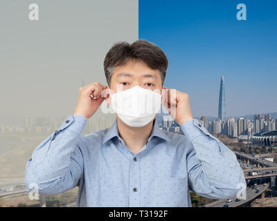 Un homme d'âge moyen portant un masque en arrière-plan d'une ville pleine de poussière fine. Banque D'Images