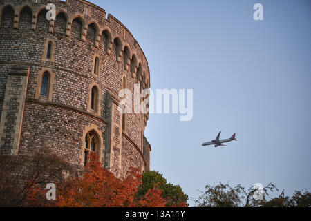 Windsor, Royaume-Uni - décembre 2018. Détail de la tour ronde du château de Windsor, résidence royale dans le Berkshire, à l'approche d'un avion Heathrow. Banque D'Images