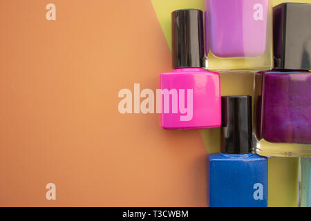 Bouteilles de vernis à ongles. Un groupe de vernis brillant sur un fond jaune, couleur. Avec l'espace vide sur la gauche. Vue de dessus Banque D'Images