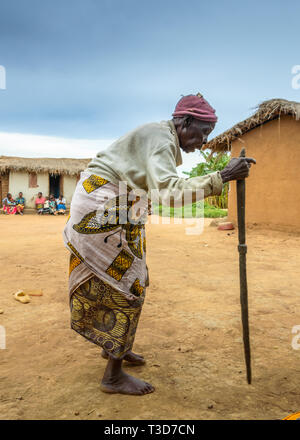 Personnes âgées femme du Malawi est en place du village en appui sur son bâton Banque D'Images