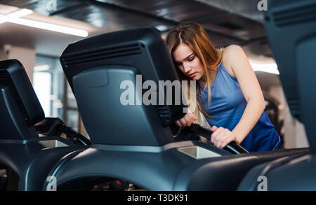 Une jeune fille ou femme faisant cardio dans une salle de sport. Banque D'Images