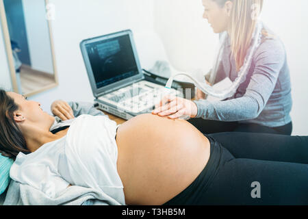 Médecin d'effectuer une échographie de femme enceinte Banque D'Images