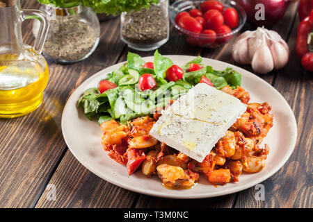 Des haricots géants au four avec fromage feta et sauce tomate. La cuisine traditionnelle grecque Banque D'Images