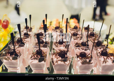 Desserts aux fruits, mousse, des biscuits. Différents types de viennoiseries, petits gâteaux sucrés colorés, macaron, et autres desserts dans le buffet sucré Banque D'Images