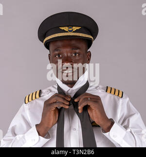 Portrait d'un pilote de ligne lier son uniforme black tie Banque D'Images