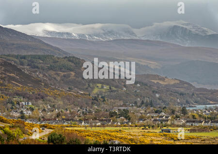 ULLAPOOL ROSS ET CROMARTY ECOSSE LA VILLE AU DÉBUT DU PRINTEMPS AVEC DE LA NEIGE ET DES NUAGES SUR LA MONTAGNE BEINN DEARG Banque D'Images