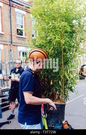 Londres, Royaume-Uni - 22 juillet 2018 : l'homme avec un bambou dans un pot sur son vélo à la Columbia Road Flower Market dans l'Est de Londres, Angleterre Banque D'Images