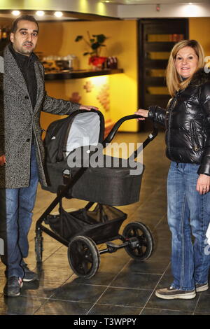 Heureux les jeunes parents avec bébé en perambulator en italien Ristorante à Kiev par une journée d'hiver Banque D'Images