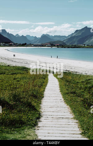 Le chemin de caillebotis menant à Ramberg plage et montagne littoral sur l'île de Flakstadøya dans l'archipel des Lofoten en Norvège Nordland Banque D'Images