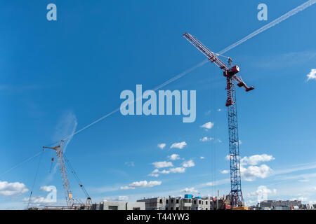 Deux grandes grues de construction sur fond de ciel bleu. travailleurs construisent house Banque D'Images