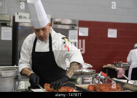 Le s.. Carlos Mercado, officier sous-culinaire avancé, tranches de porc le 11 mars au cours de l'exercice de formation culinaire cuisine mobile de compétition à remorque Maclaughlin centre de remise en forme, Fort Lee, Va. La Isabela, Puerto Rico-autochtone sert à 426e Bataillon de soutien de la Brigade, 1e Brigade Combat Team, 101st Airborne Division (Air Assault). La 44e conférence annuelle des JCTE en vedette les talents de plus de 200 chefs militaires de partout dans le monde comme la plus grande American Culinary Federation et dirigée par la concurrence en Amérique du Nord. L'exercice, administré par le Centre Culinaire commune o Banque D'Images