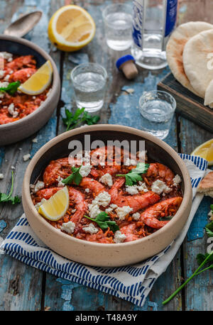 Crevettes saganaki de feta sur une plaque sur une table. Banque D'Images