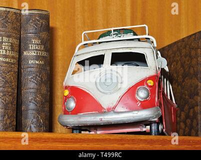 La boîte de jouets anciens, ici red bus ou voiture VW peint avec des fleurs Banque D'Images