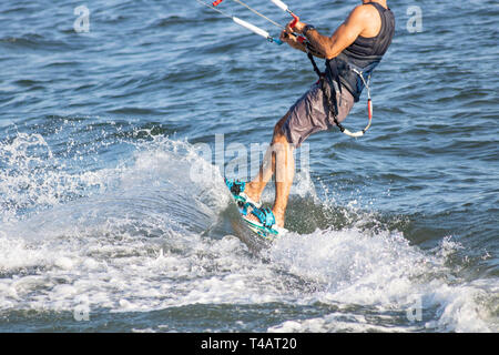 Tourné sur le conseil d'un kitesurfeur en prenant une vague Banque D'Images