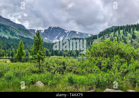 L'un des sept lacs, la montagne la plus propre Karakol situé dans la vallée au pied du col Bagatash, montagnes de l'Altaï, en Russie. Les forêts de conifères reflec Banque D'Images