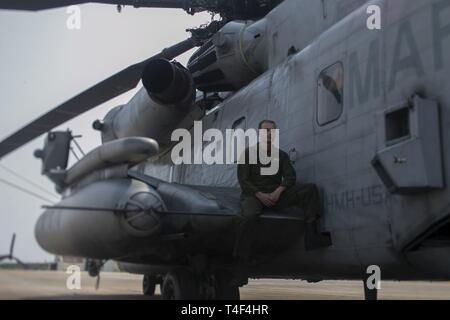 Lance le Cpl. Richard T. Henz, un CH-53E Super Stallion avec équipage d'hélicoptère 31e Marine Expeditionary Unit situé le long d'un hélicoptère CH-53E à Futenma Marine Corps Air Station, Okinawa, Japon, le 28 mars 2019. Henz, originaire de Mansfield, Texas, est diplômé de l'École secondaire l'Héritage en Mai 2014 avant de s'enrôler en octobre 2016. Henz a rejoint le Marine Corps pour mieux lui-même comme un chef de file, et d'un suiveur. Depuis Henz a été dans il a appris à propos de la patience avec le travail qu'il fait et avec les autres. Banque D'Images