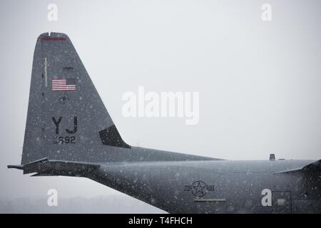 Un 36e Escadron de transport aérien C-130J Super Hercules est assis sur la piste pendant une tempête de neige de fin de saison le 10 avril 2019, à Yokota Air Base, le Japon. Par la pluie, grésil, grêle, ou la neige, les membres de l'équipe de Yokota de respecter les mission. Banque D'Images