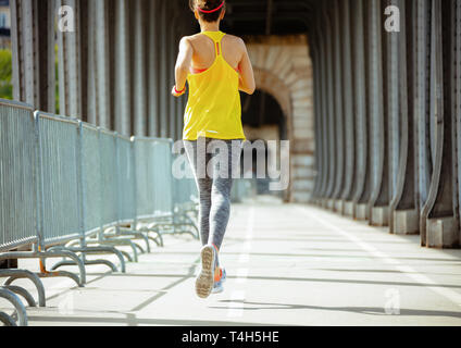 Vus de derrière, les sports actifs en femme fitness clothes sur Pont de Bir-Hakeim pont de Paris le jogging. Banque D'Images