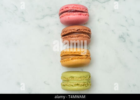 Voir ci-dessus des macarons colorés sur un fond de marbre Banque D'Images