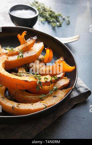 Citrouille cuite rôtie, avec plus le thym et le sel aromatique. La nourriture végétalienne saine. Close up. Banque D'Images