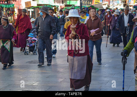 Les pèlerins du bouddhisme tibétain, des moines, les habitants, et les touristes se promènent, une dévotion populaire Barkor à vélo autour du temple du Jokhang à Lhassa, Tibet Banque D'Images