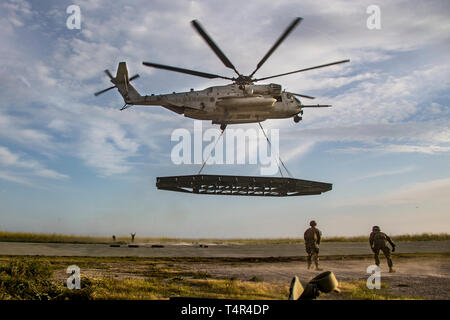 Les Marines américains avec la Compagnie de soutien d'atterrissage, 1er Bataillon de soutien du transport, 1er Groupe Logistique Maritime, regarder comme un CH-53E Super Stallion décolle avec un pont moyen (MGB) au Marine Corps Base Camp Pendleton, en Californie, le 11 avril 2019. La formation a été menée d'employer une équipe de soutien et d'hélicoptères CH-53E Super Stallion pour soulever une MGB pour valider les méthodes de mise en place de ponts traditionnels. (U.S. Marine Corps photo par Lance Cpl. Betzabeth Y. Galvan) Banque D'Images