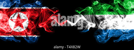 La Corée du Nord contre la Sierra Leone smoky mystic drapeaux placés côte à côte. La fumée épaisse et soyeuse de couleur drapeaux de la Corée du Nord et en Sierra Leone. Banque D'Images