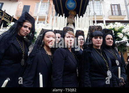 Palma, Espagne. Apr 19, 2019. Lucie et l'autre posent devant les bons Manolas procession Vendredi à Palma. Il y a trois décennies, les femmes ont été interdit de s'habiller comme Capirote. Leur seule possibilité de participer à la procession a été de porter la Mantilla, habillé comme une Manola. Au cours des dernières années, certaines jeunes femmes ont rejoint la tradition à nouveau et porter les vêtements traditionnels. Credit : Clara Margais/dpa/Alamy Live News Banque D'Images