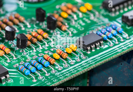 Composants électroniques. Les circuits intégrés, des résistances, des transistors ou des condensateurs sur PCB. Conseil de cuivre vert détail. Code couleur standard. Le tri des déchets. Banque D'Images