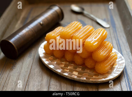 Dessert traditionnel appelé tulumba. Une cuisine turque. La cuisine des Balkans. La cuisine levantine. Sur un fond de bois, servi sur une plaque, dans oriental vintage Banque D'Images